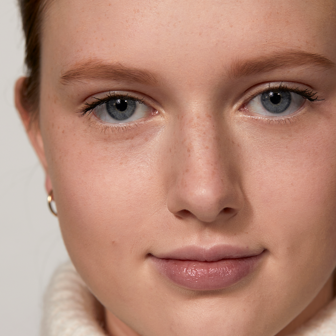 A woman showing her results after using The Brow Pencil in Blonde by Jones Road Beauty
